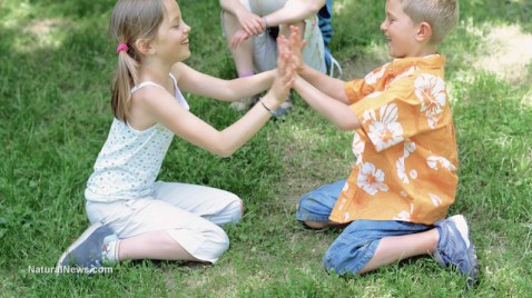 children-play-patty-cake-park-grass